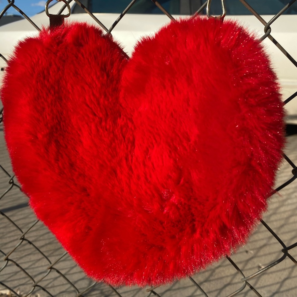 Fluffy red heart shaped purse with gold chain.